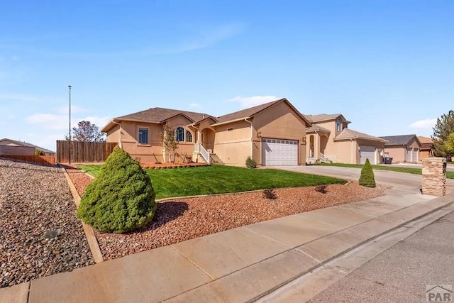 ranch-style home with concrete driveway, a residential view, an attached garage, fence, and stucco siding