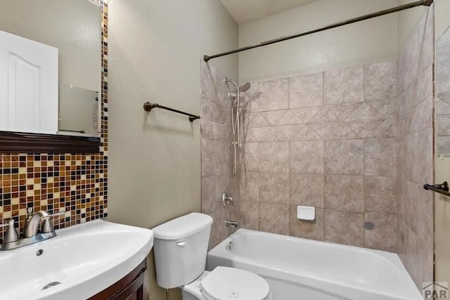 full bath with shower / washtub combination, toilet, vanity, and decorative backsplash