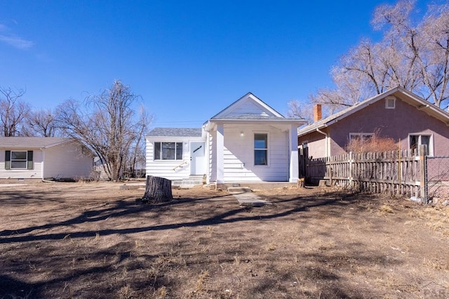 back of house with fence