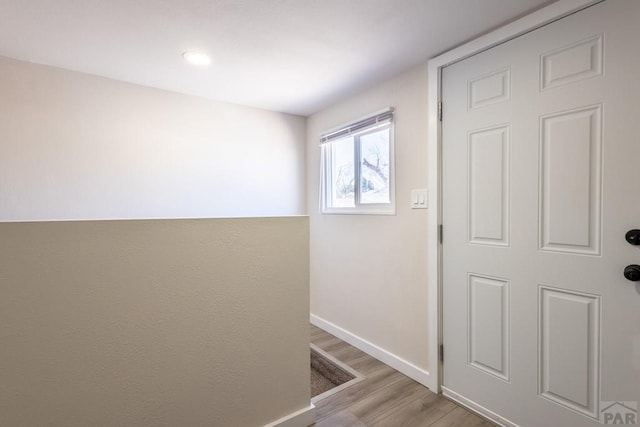 entryway featuring light wood-style flooring and baseboards