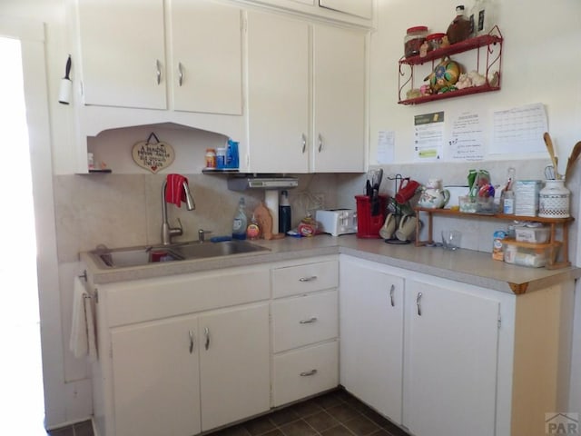 1724 E Abriendo Ave, Pueblo, CO 81004 - kitchen with a sink, tasteful backsplash, light countertops, and white cabinetry