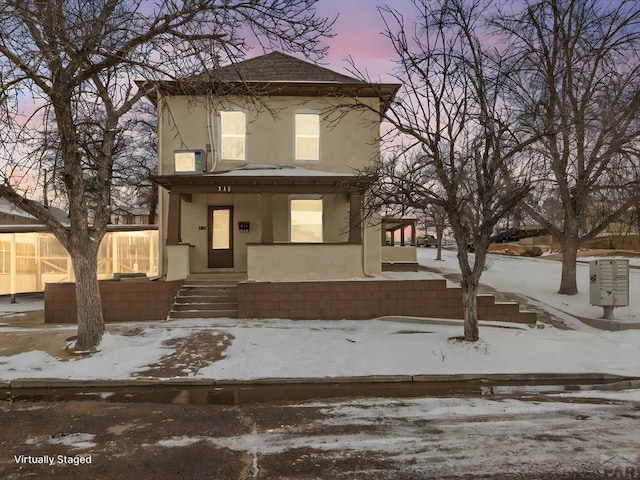 view of front of house with roof with shingles and stucco siding