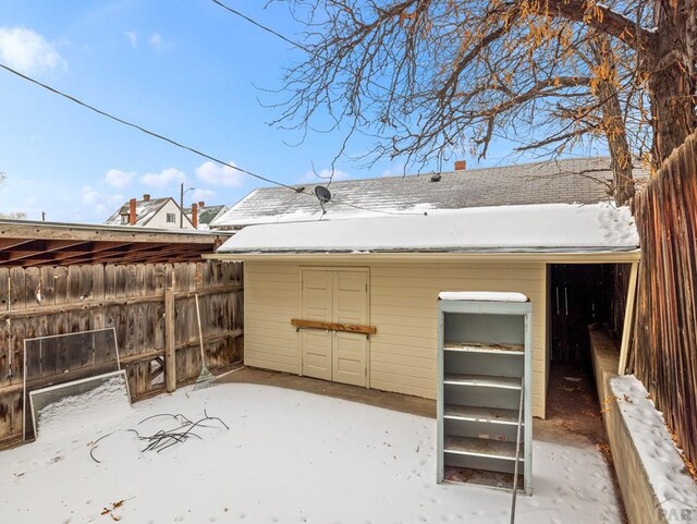 yard layered in snow featuring fence