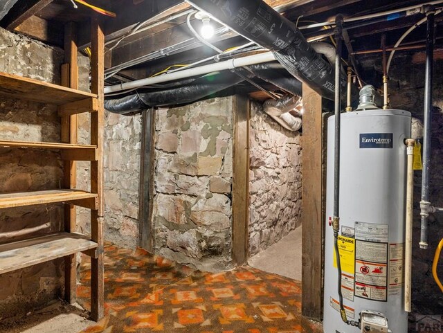 unfinished below grade area featuring water heater