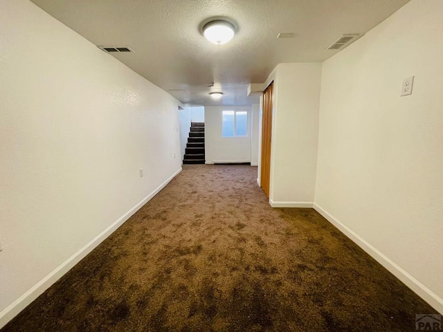 interior space featuring stairway, carpet flooring, visible vents, and baseboards