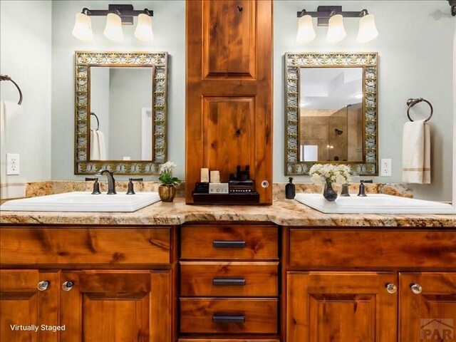 full bathroom featuring double vanity and a sink