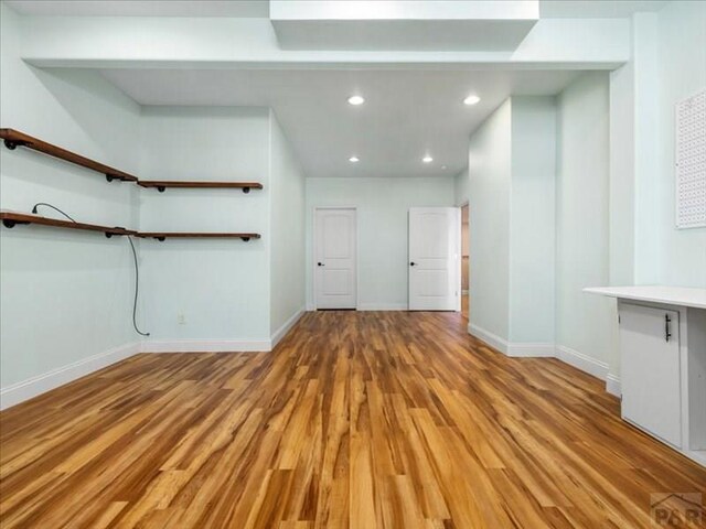 interior space featuring light wood-type flooring, baseboards, and recessed lighting