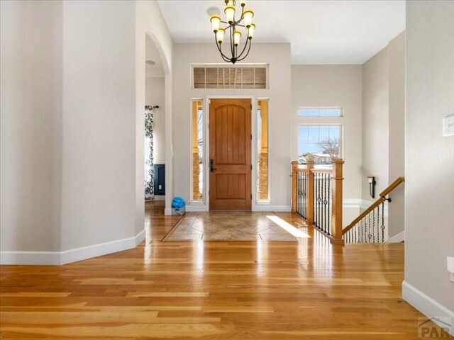 entrance foyer featuring visible vents, baseboards, and wood finished floors