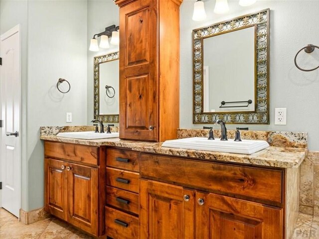 full bathroom featuring a sink and double vanity