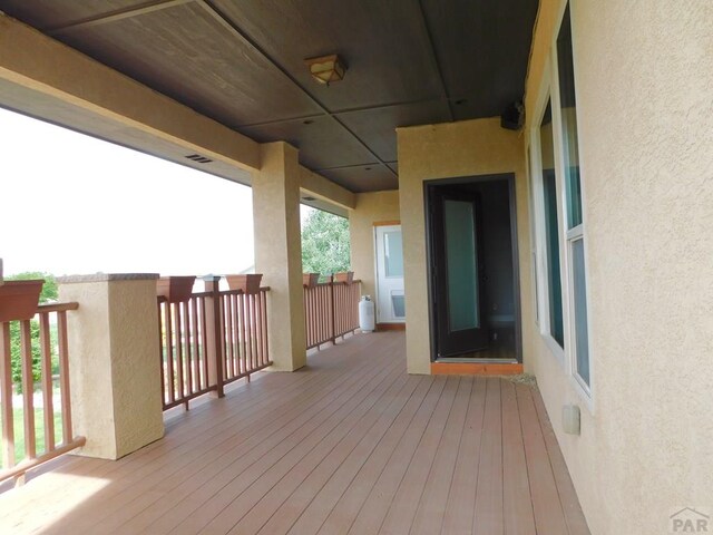 wooden deck featuring visible vents