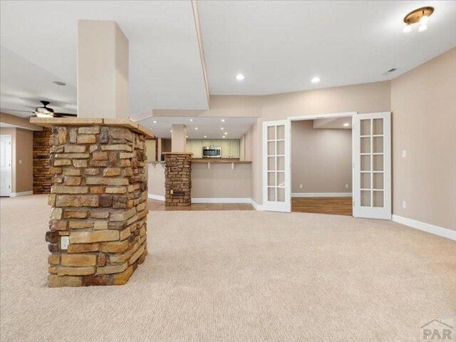 unfurnished living room featuring ceiling fan, recessed lighting, light carpet, baseboards, and french doors