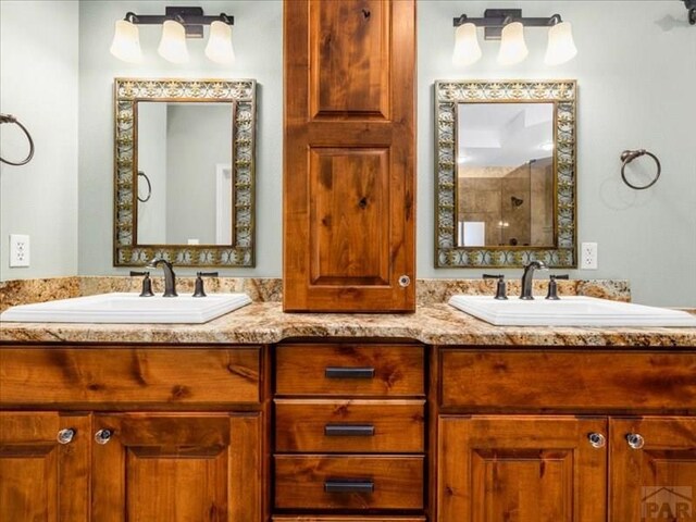 bathroom featuring a sink and double vanity