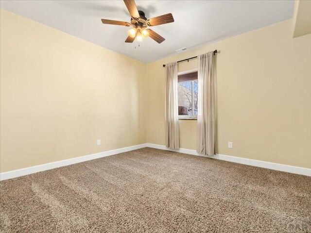 unfurnished room featuring carpet flooring, ceiling fan, and baseboards