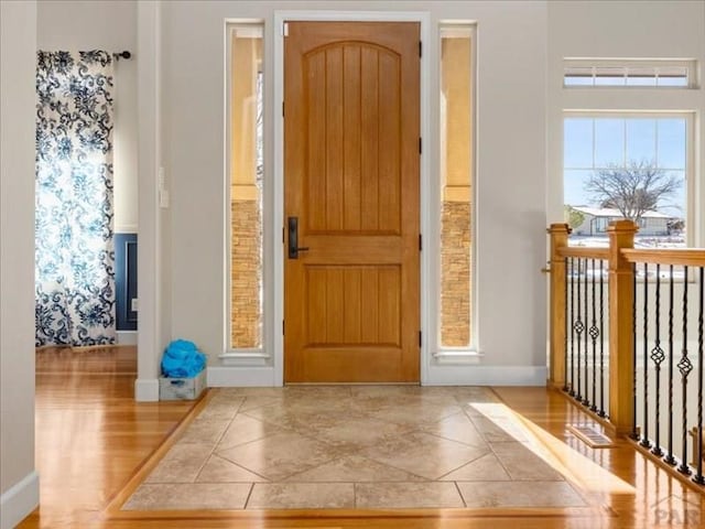 foyer featuring a wealth of natural light and baseboards