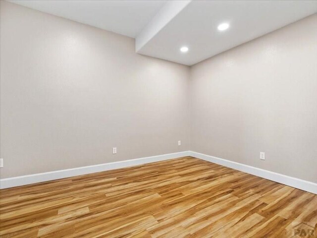 empty room with light wood-style floors and baseboards