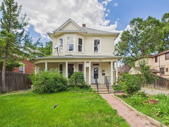 411 Michigan St, Pueblo, CO 81004 - victorian-style house with covered porch and a chimney