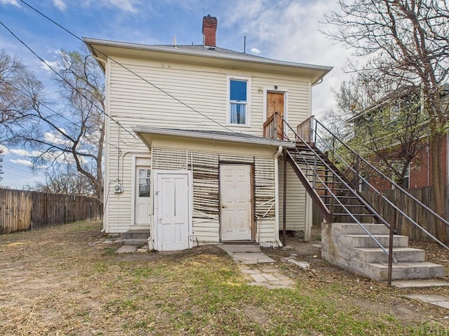 411 Michigan St, Pueblo, CO 81004 - back of property featuring entry steps, stairs, and a chimney