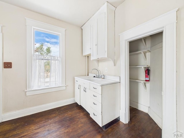 411 Michigan St, Pueblo, CO 81004 - kitchen featuring dark wood-style floors, white cabinets, and light countertops