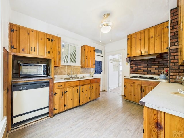 411 Michigan St, Pueblo, CO 81004 - kitchen with dishwasher, light wood finished floors, light countertops, and a ceiling fan
