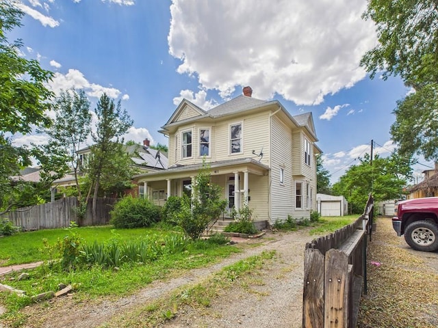 411 Michigan St, Pueblo, CO 81004 - victorian-style house with a chimney, a porch, and a garage