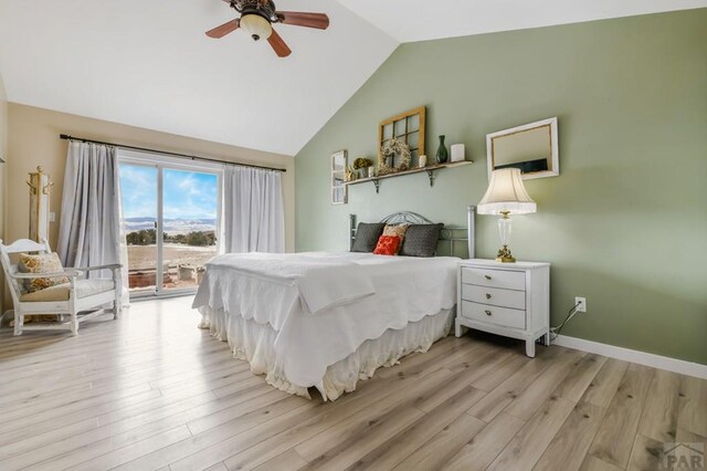 bedroom featuring light wood-style floors, access to outside, vaulted ceiling, and baseboards