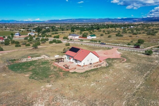 drone / aerial view featuring a rural view and a mountain view