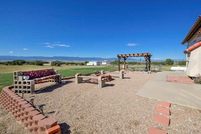 view of yard with a mountain view and a patio