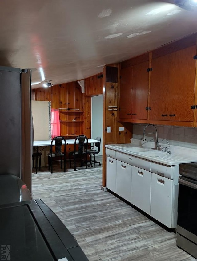 kitchen featuring light countertops, brown cabinetry, and stainless steel appliances