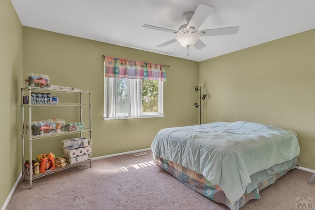 bedroom featuring light carpet, ceiling fan, and baseboards