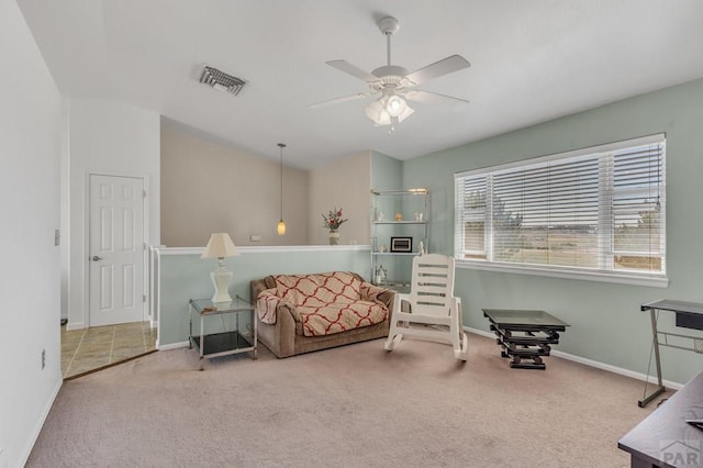 living area featuring baseboards, carpet, visible vents, and a ceiling fan