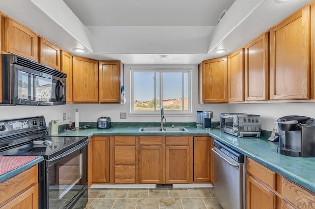 kitchen featuring a raised ceiling, a toaster, a sink, and black appliances