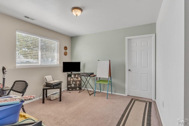 office with visible vents, light carpet, and baseboards