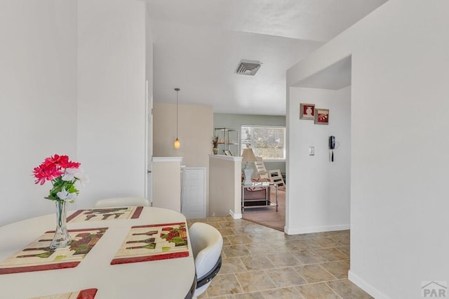 dining room featuring visible vents and baseboards