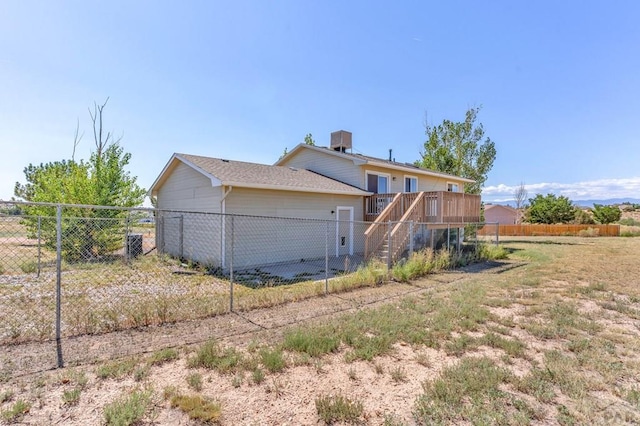 back of property featuring stairs, fence, and a deck