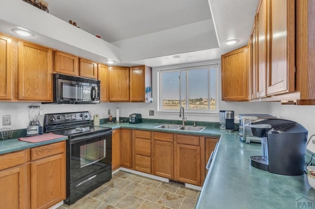 kitchen with recessed lighting, a sink, black appliances, a tray ceiling, and brown cabinetry