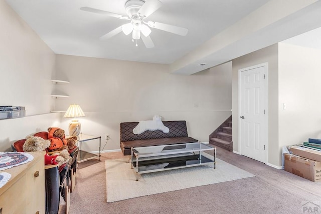 sitting room with stairway, carpet flooring, a ceiling fan, and baseboards