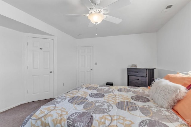 carpeted bedroom featuring ceiling fan and visible vents