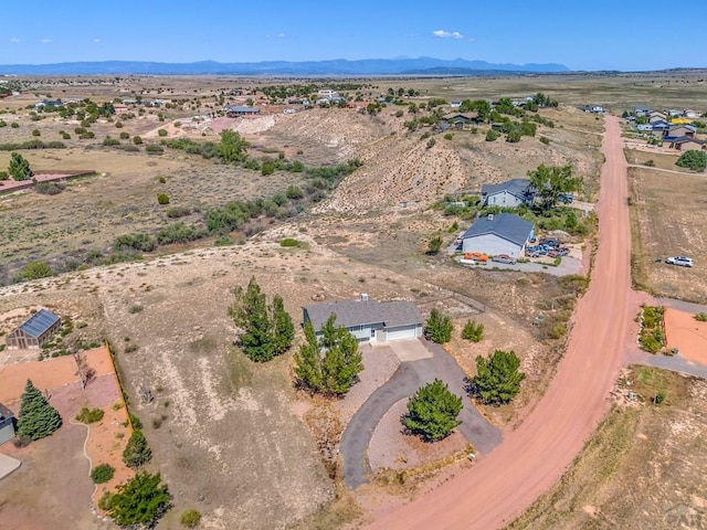 birds eye view of property with a mountain view