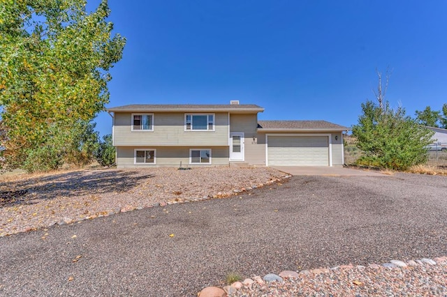 tri-level home featuring a garage and driveway