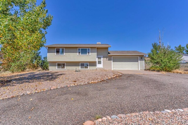 tri-level home featuring a garage and driveway