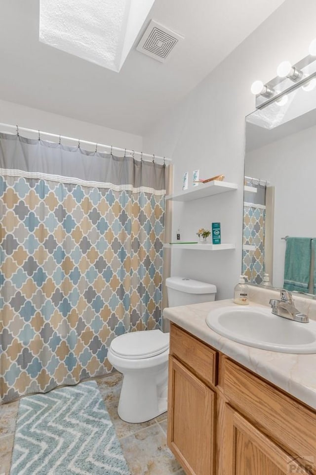 full bath with toilet, vanity, and visible vents