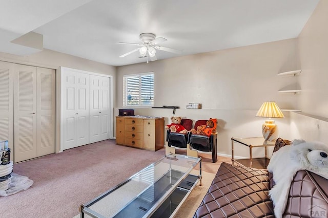 living room featuring a ceiling fan and light colored carpet