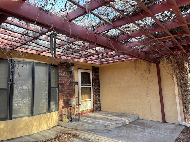 property entrance featuring brick siding and stucco siding