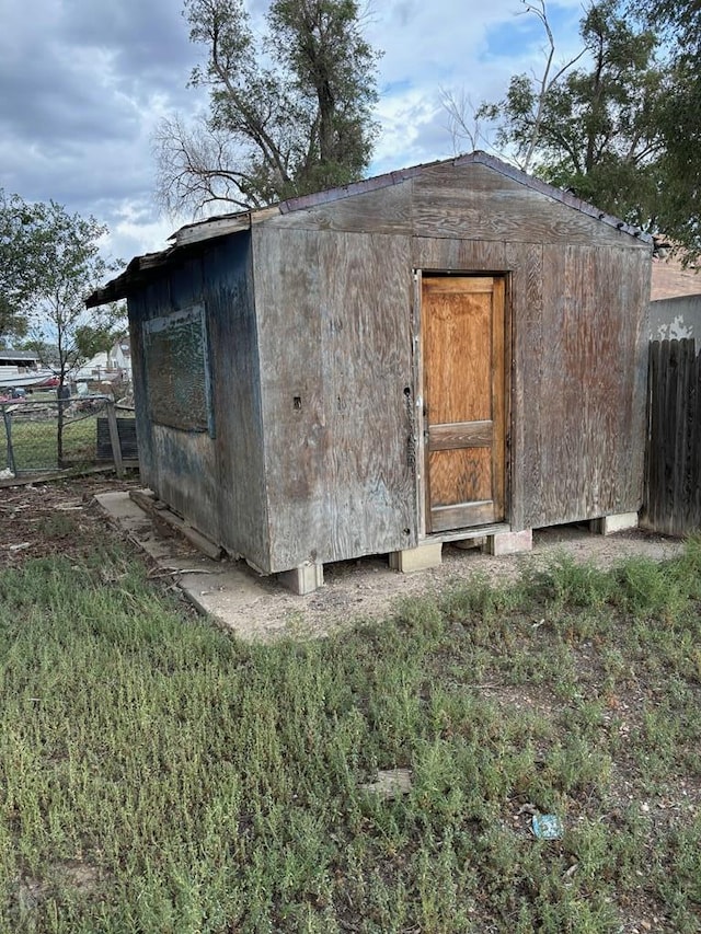 view of shed featuring fence