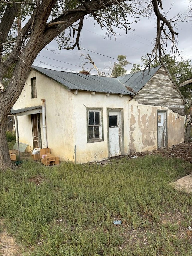 rear view of property with stucco siding