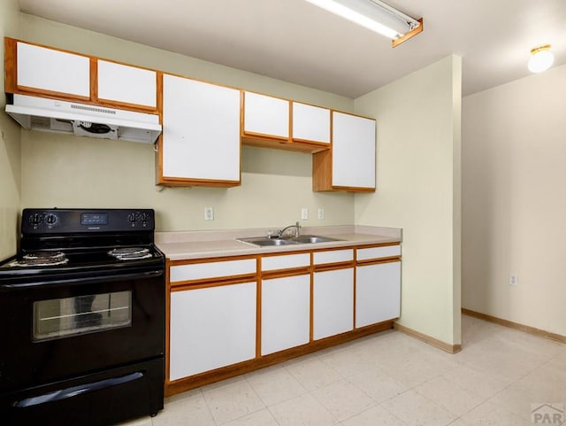 kitchen featuring light countertops, white cabinets, a sink, under cabinet range hood, and black / electric stove