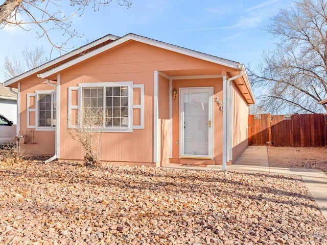 bungalow-style house with fence