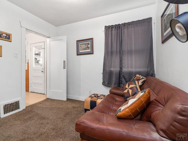 1128 W Summit Ave, Pueblo, CO 81004 - carpeted living room with baseboards