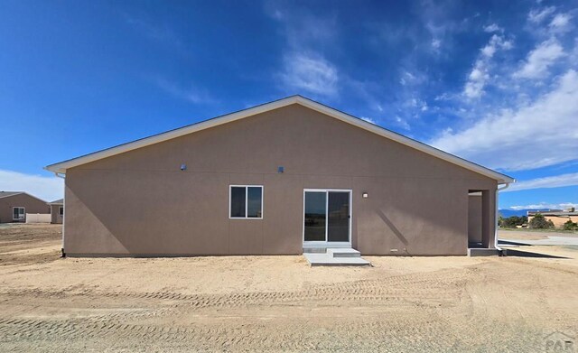 back of house with stucco siding