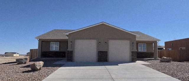 ranch-style house featuring driveway, an attached garage, and stucco siding